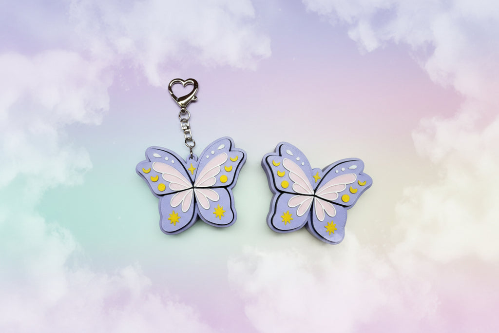 Butterfly-shaped keychains on a pastel gradient background